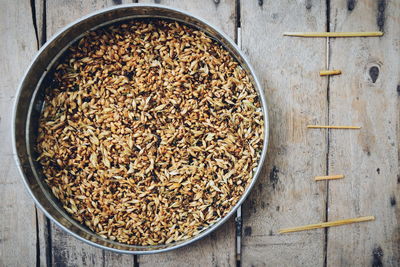 Directly above shot of wheat in container on table