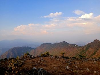 Scenic view of mountains against cloudy sky