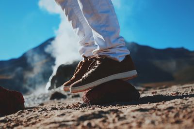 Low section of man balancing on rock at atacama desert