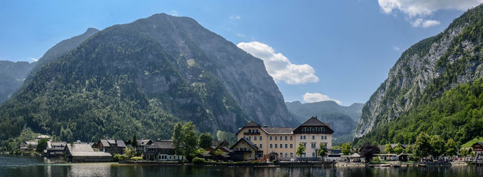 Panoramic view of buildings and mountain against sky