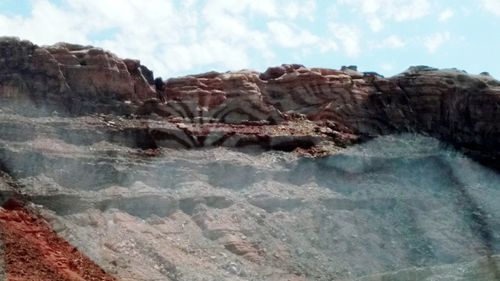 Rock formations in sea against sky
