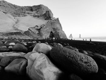 Rocks on beach against clear sky