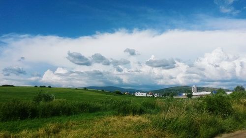 Scenic view of landscape against cloudy sky