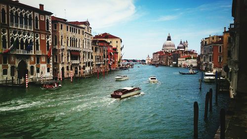 Boats in river with buildings in background