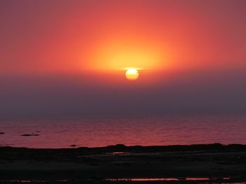 Scenic view of sea against romantic sky at sunset