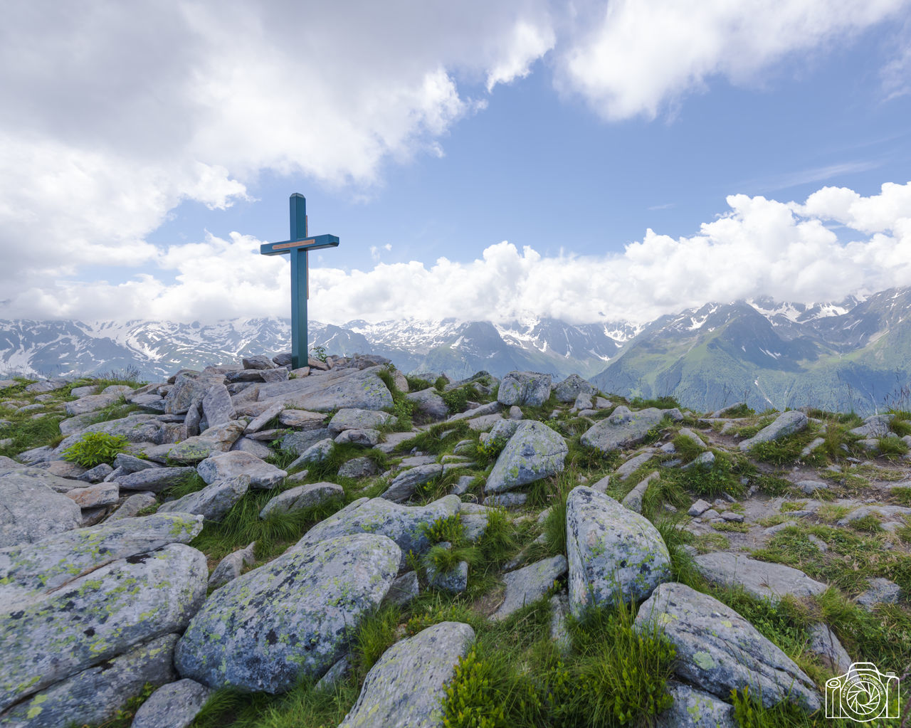 sky, mountain, cross, cloud - sky, solid, beauty in nature, day, nature, religion, no people, tranquility, rock, belief, tranquil scene, spirituality, rock - object, scenics - nature, non-urban scene, architecture, mountain range, symbol, outdoors