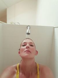 Close-up of young woman in bathroom