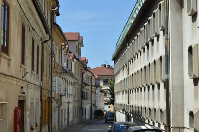 Street amidst buildings against sky in city