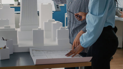 Midsection of businessman standing in office