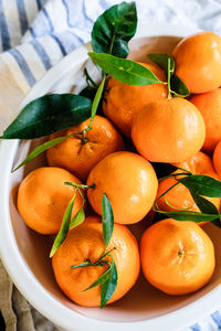 Close-up of orange fruit in container