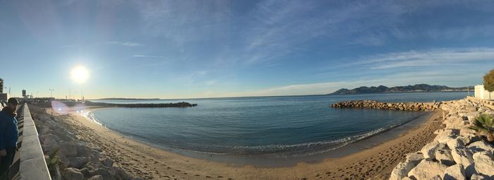 Panoramic view of beach against sky during sunset