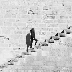 Man and woman walking on wall