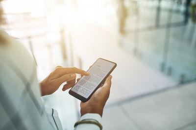 Midsection of woman using mobile phone