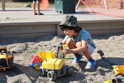 Portrait of boy playing with toy car