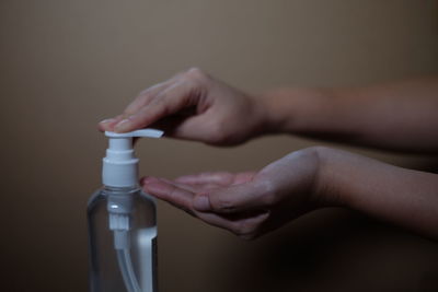 Close-up of human hand holding bottle