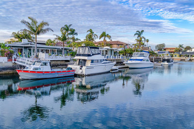 Boats moored in sea against sky