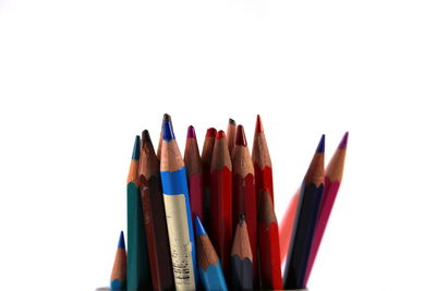 Close-up of colored pencils against white background