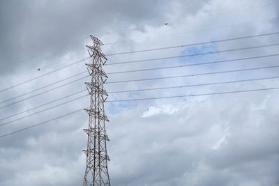 Low angle view of electricity pylon against sky