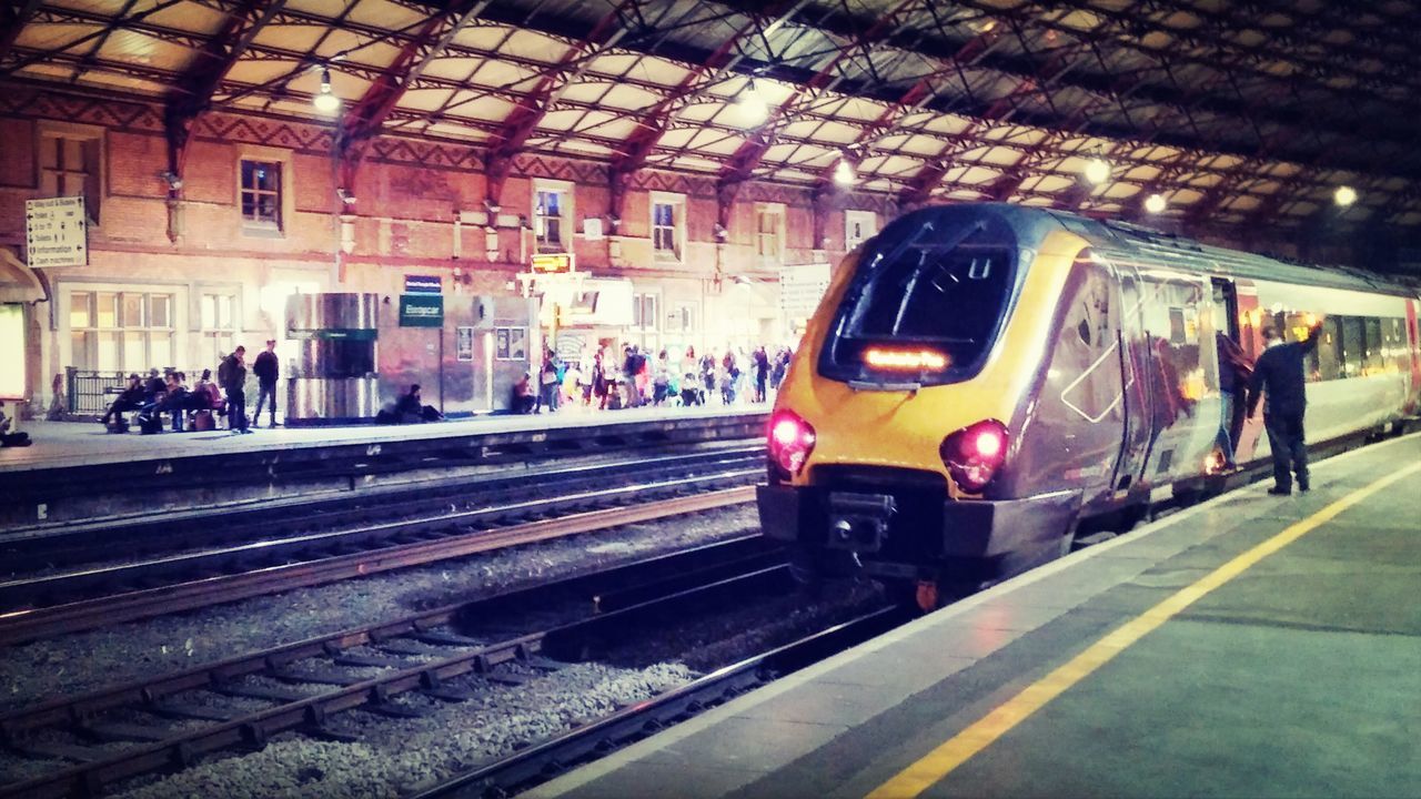 transportation, railroad track, railroad station platform, public transportation, railroad station, rail transportation, mode of transport, travel, men, lifestyles, person, land vehicle, train - vehicle, incidental people, on the move, city life, street, road marking, road