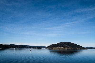 Scenic view of calm sea against cloudy sky