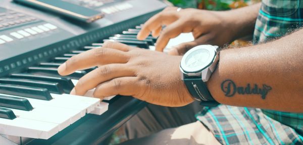 Close-up of man playing piano