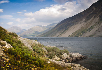 Scenic view of sea and mountains against sky