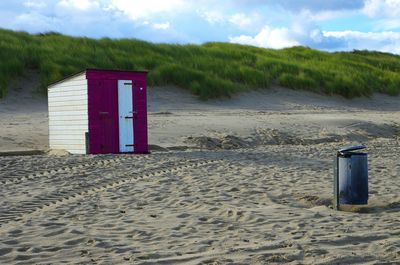 Lifeguard hut on beach against sky