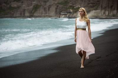 Full length of woman walking at beach