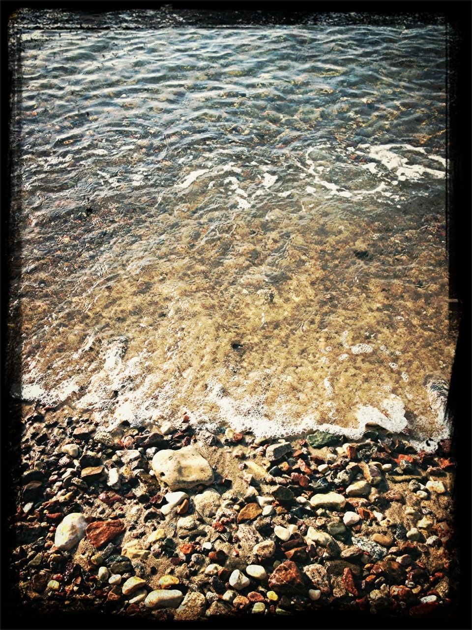 transfer print, water, auto post production filter, high angle view, tranquility, nature, rock - object, shore, stone - object, sea, beach, rippled, tranquil scene, pebble, beauty in nature, outdoors, scenics, lake, day, stone