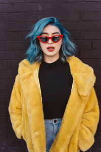 Portrait of woman wearing sunglasses standing outdoors