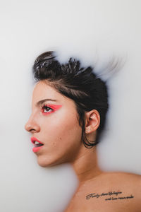 Thoughtful young woman taking milk bath