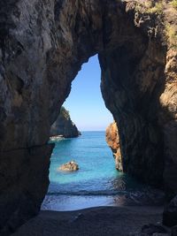 Scenic view of sea seen through cave