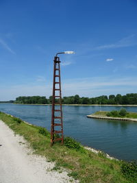 Scenic view of river against blue sky