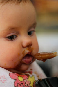 Close-up portrait of cute boy eating food