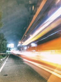 Light trails on road in city at night