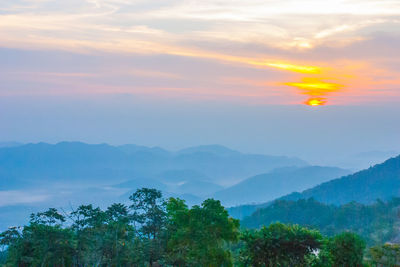 Scenic view of mountains against sky at sunset