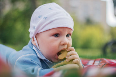 Portrait of cute baby girl eating outdoors