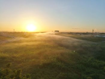Scenic view of field against clear sky during sunset