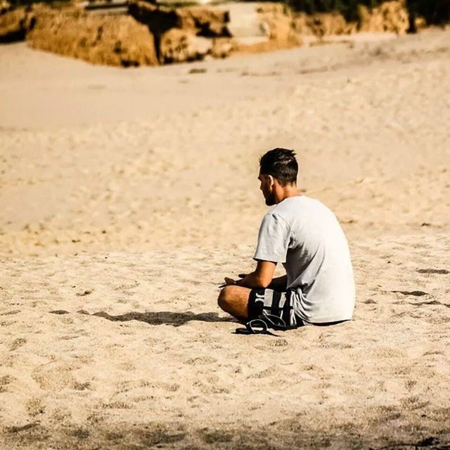 sand, beach, lifestyles, leisure activity, full length, casual clothing, focus on foreground, shore, rear view, sitting, childhood, day, sunlight, men, outdoors, selective focus, side view, relaxation