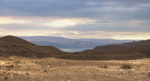 Scenic view of arid landscape against sky