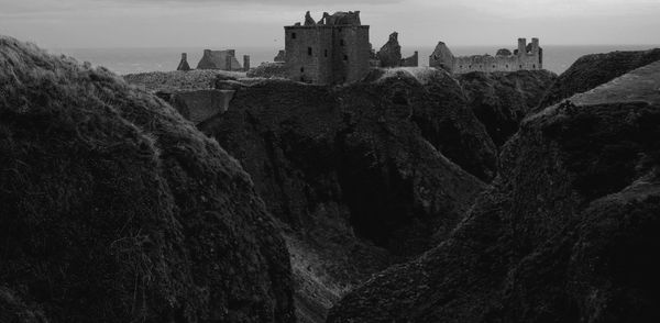 Dunnottar castle on mountain against sky