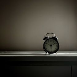 Close-up of alarm clock on table at home