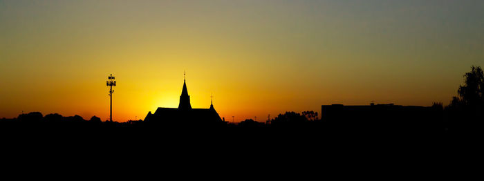 Silhouette of building at sunset