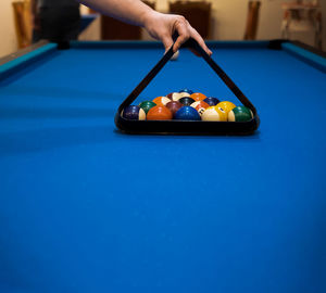 Cropped hand playing pool