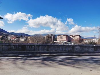 Buildings in city against cloudy sky