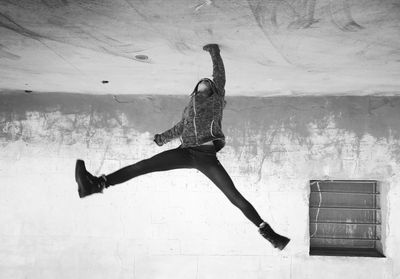 Girl practicing handstand against wall