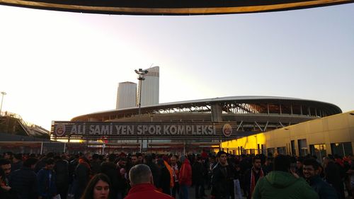 Crowd at town square against clear sky