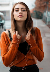 Portrait of beautiful young woman standing outdoors