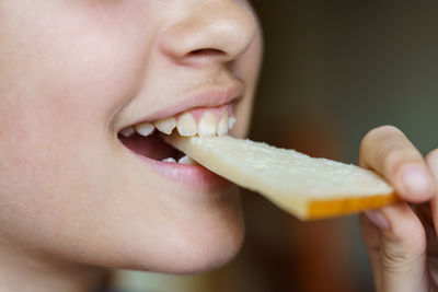 Close-up of young woman eating food