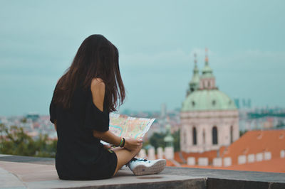 Woman sitting against the sky